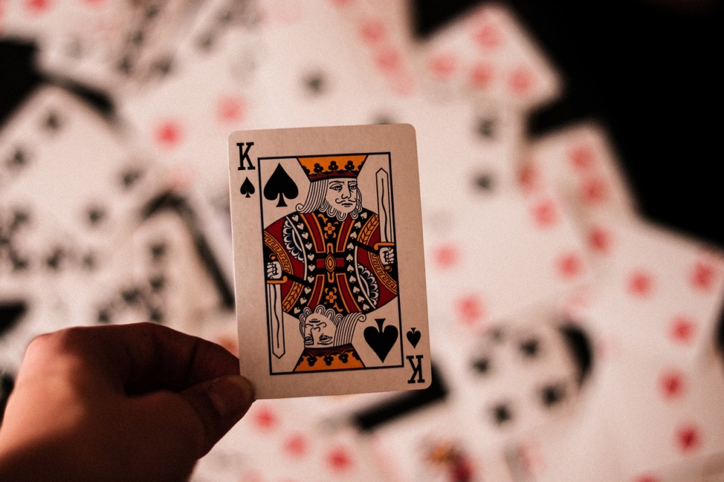 Hand holding king of spades card